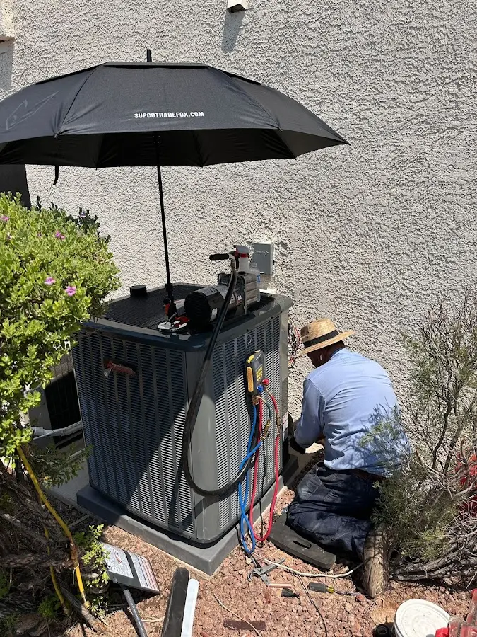 HVAC technician performing outdoor AC maintenance in Montague
